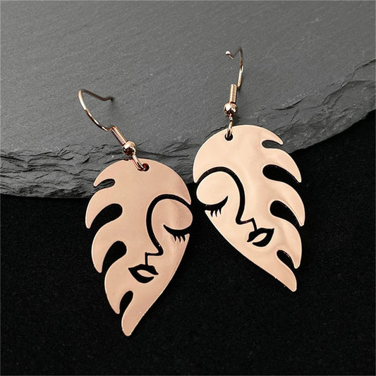 Boucles d'oreilles plumes visage femme